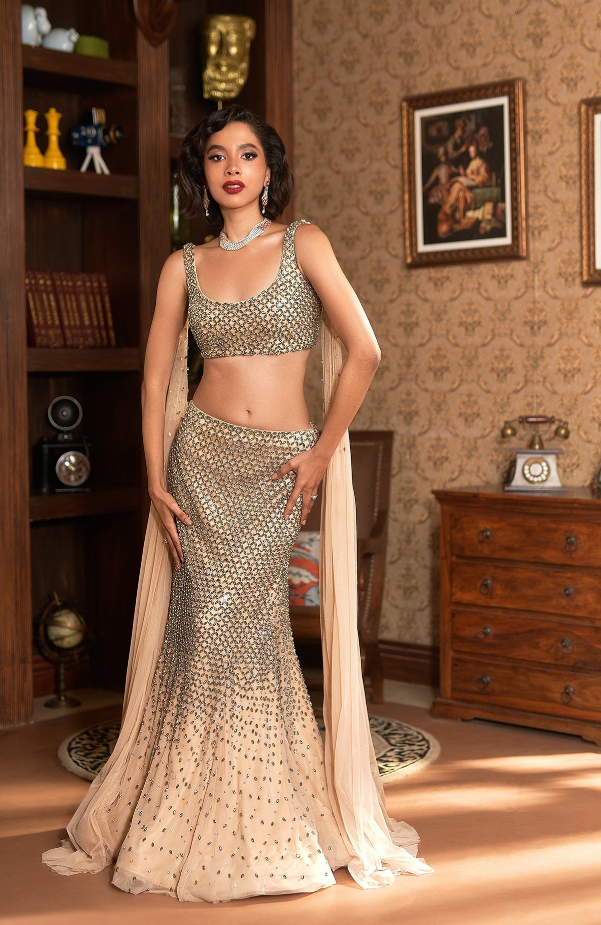 Champagne gold mermaid lehenga with silver crystal embroidery and sheer shoulder cape.