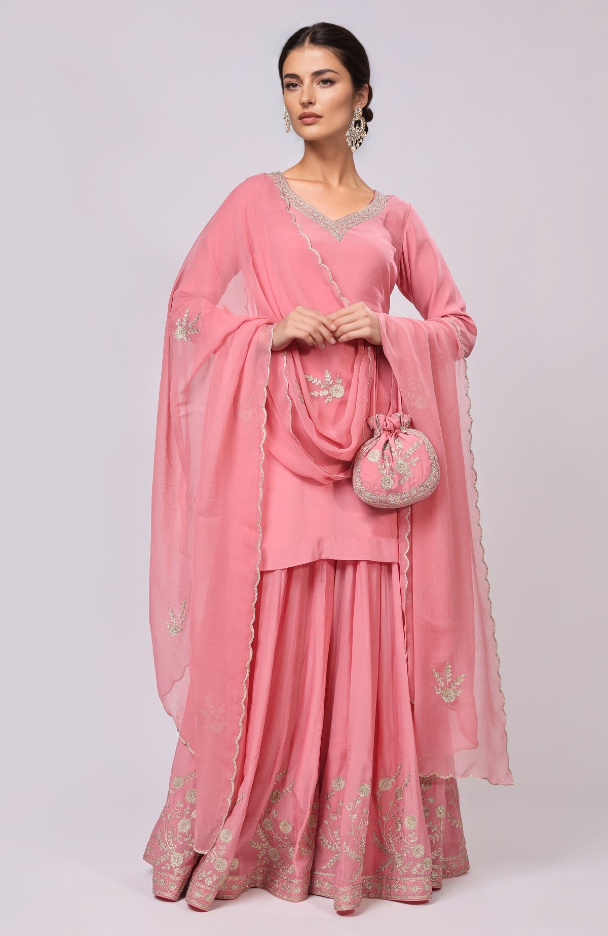 Pink Kashmiri Tilla Aari embroidered sharara set with a matching potli bag.