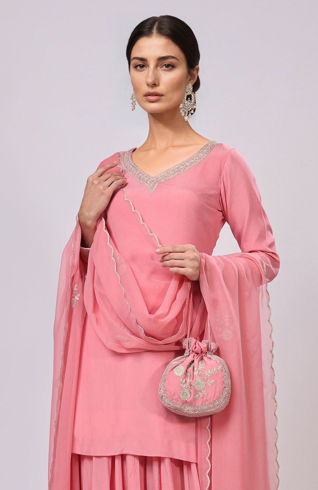 Pink Kashmiri Tilla Aari embroidered sharara set with a matching potli bag.