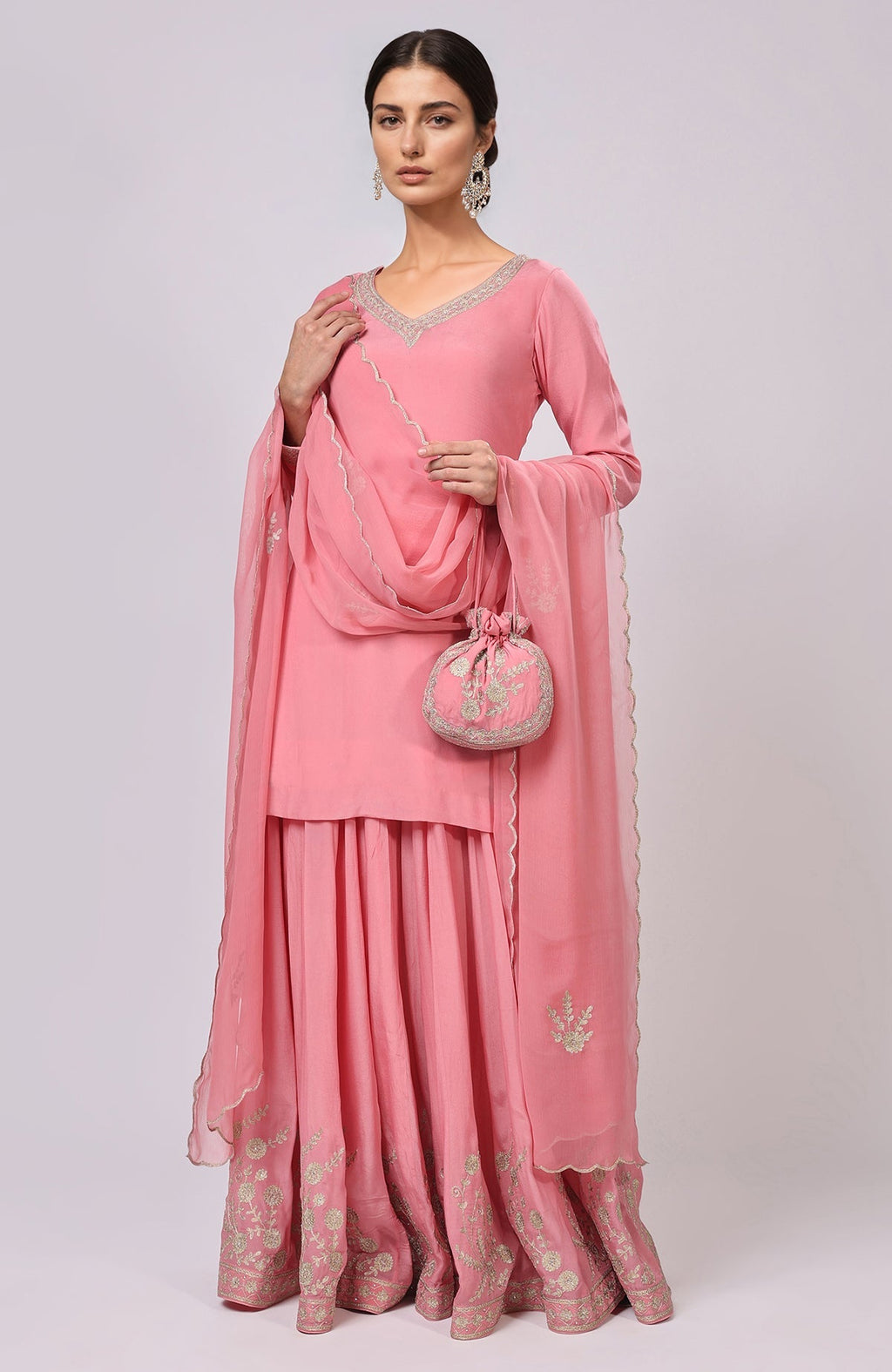 Pink Kashmiri Tilla Aari embroidered sharara set with a matching potli bag.