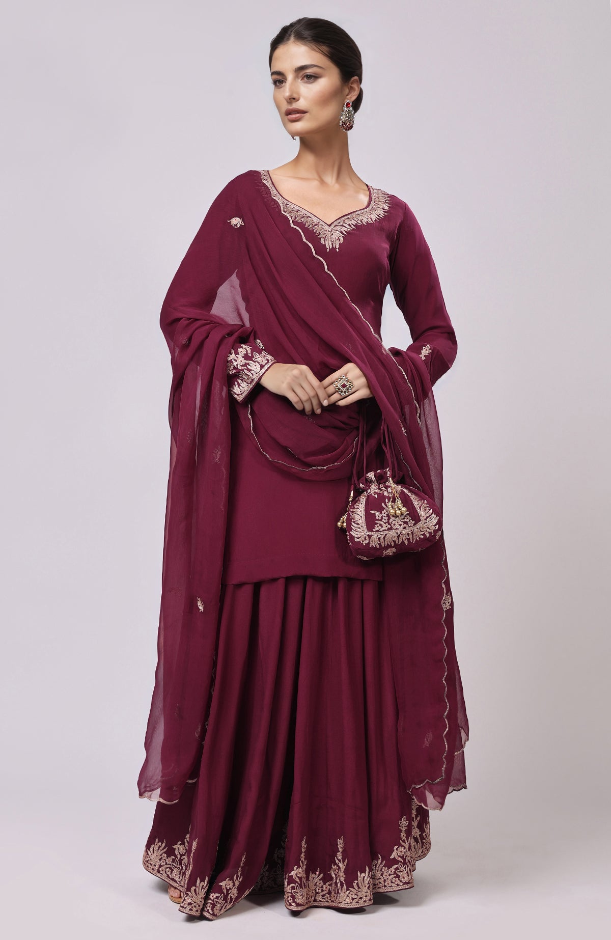 Burgundy sharara set with Kashmiri Tilla Aari embroidery and a matching potli bag.