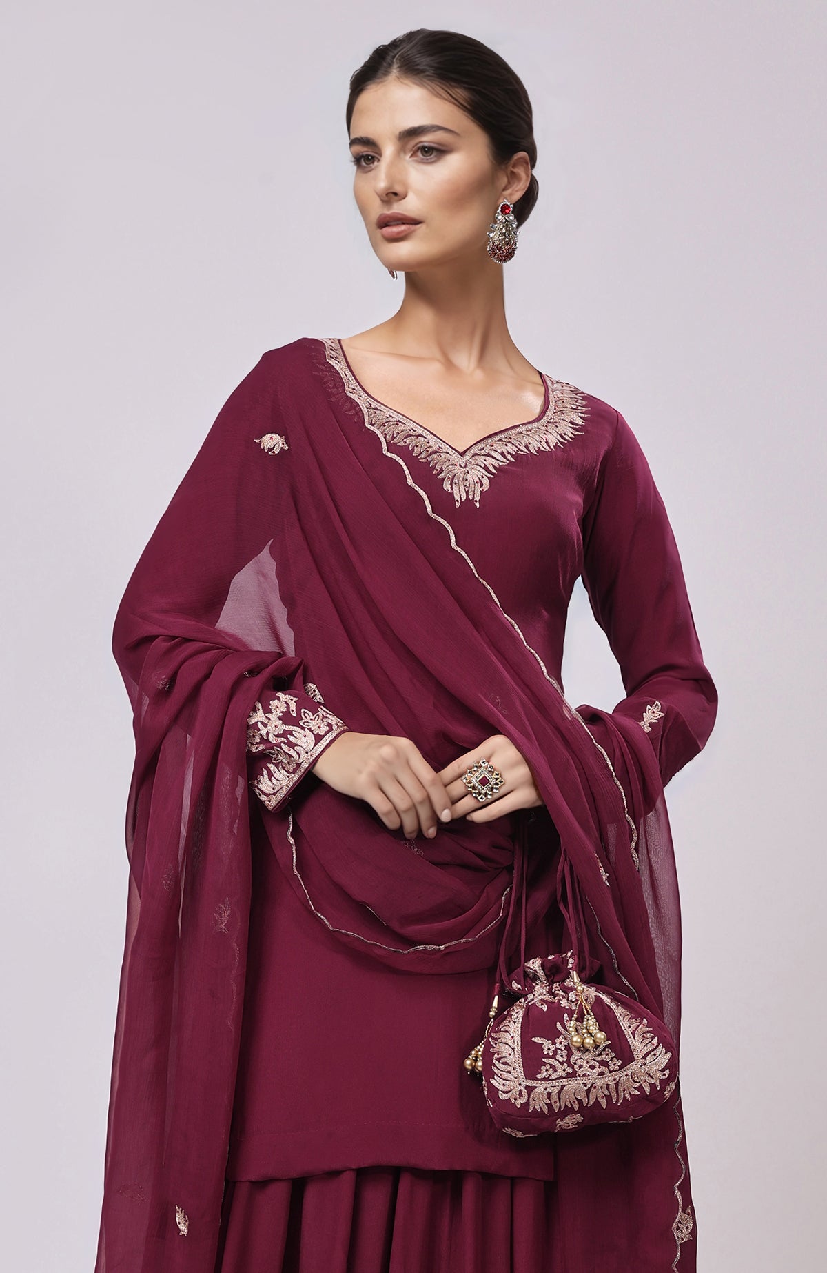 Burgundy Kashmiri Tilla Aari embroidered sharara set with matching potli bag.