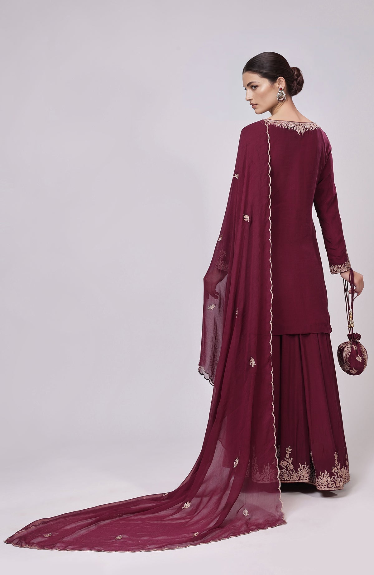 Burgundy Kashmiri Tilla Aari embroidered sharara set with matching potli bag.