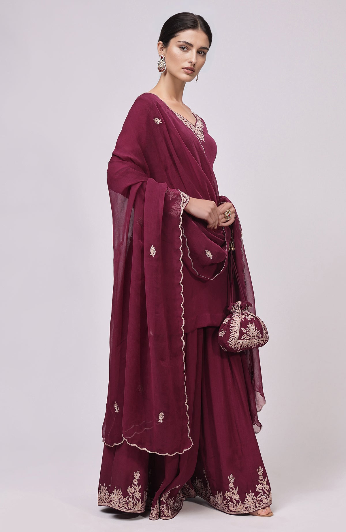 Burgundy sharara set with Kashmiri Tilla Aari embroidery and a matching potli bag.