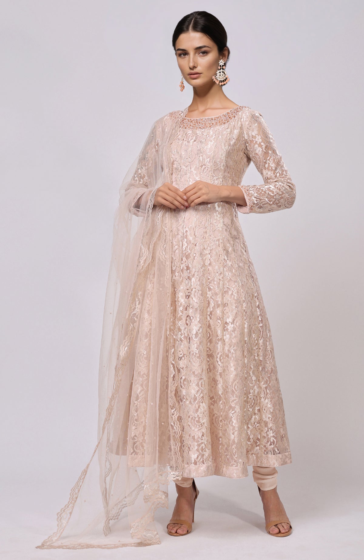A woman models a champagne lace anarkali set with a matching dupatta.