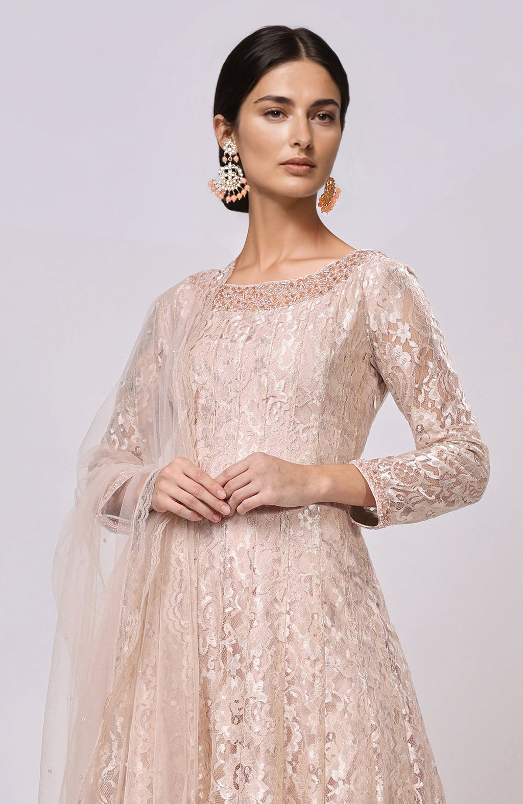 Champagne lace Anarkali set with a net dupatta and beaded earrings.