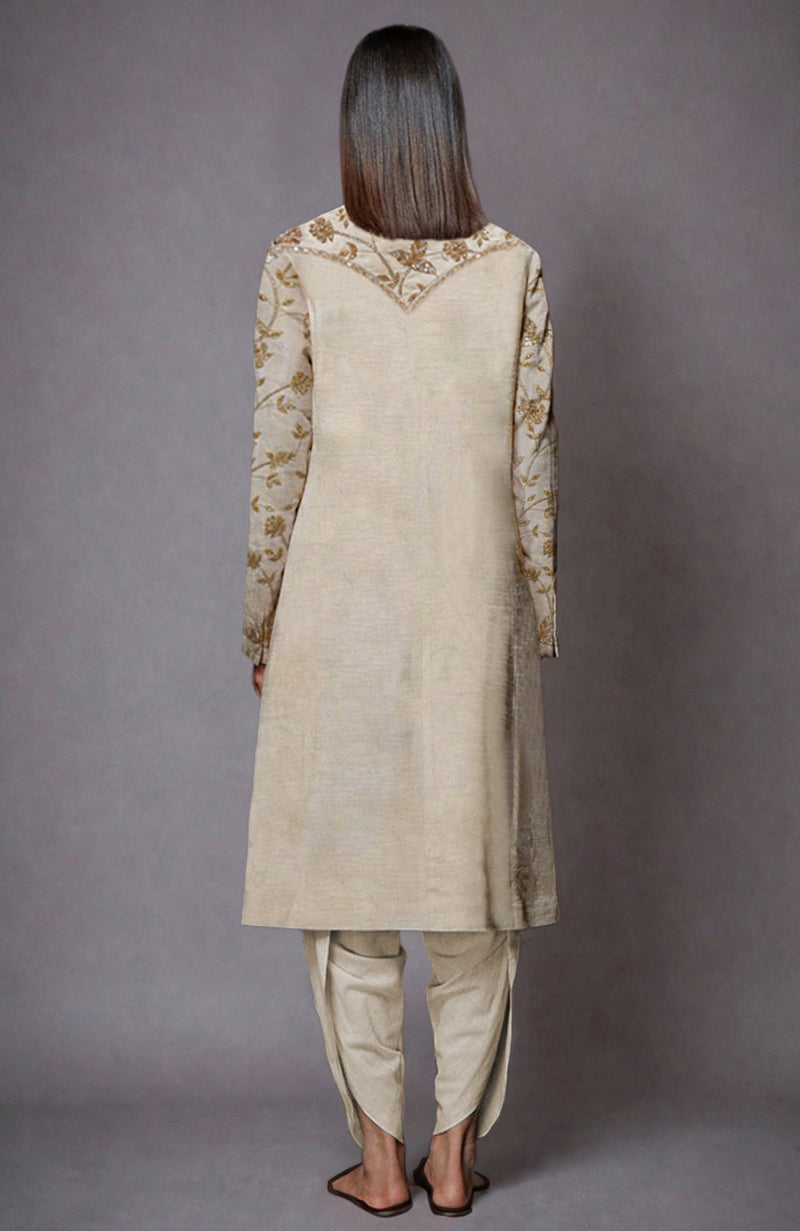 Light beige jacket set with gold zari and sequin embroidery, paired with dhoti pants.