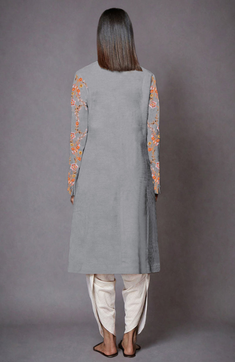 Back view of a grey jacket with floral embroidery on sleeves and ivory dhoti pants.