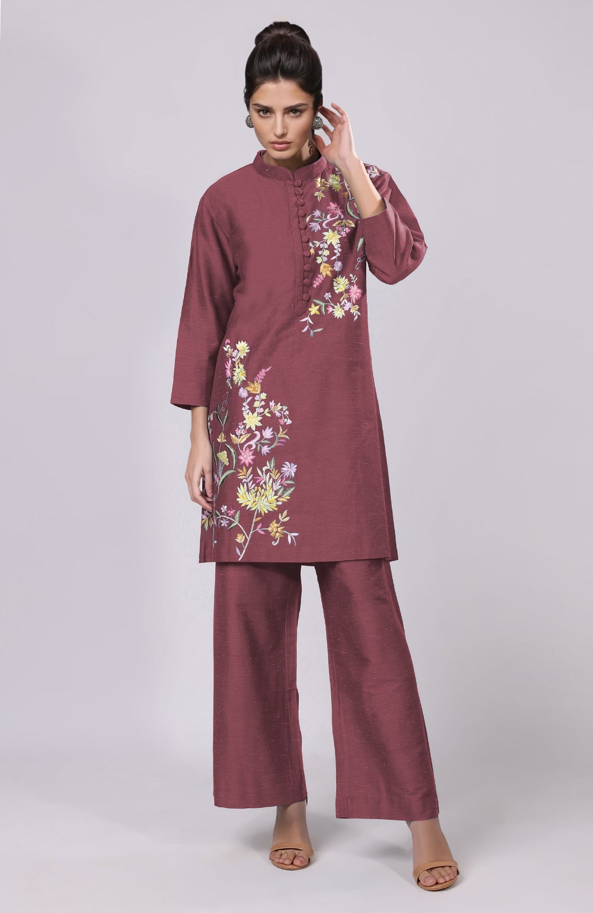 A model wears a maroon Parsi Gara embroidered co-ord set with wide-leg pants.