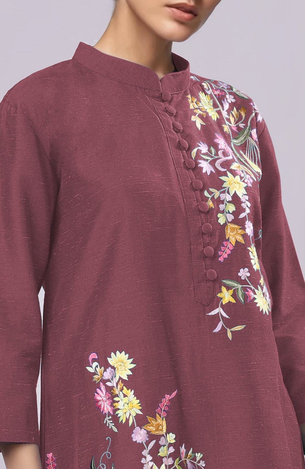 A maroon Parsi Gara embroidered co-ord set with a band collar and potli buttons.