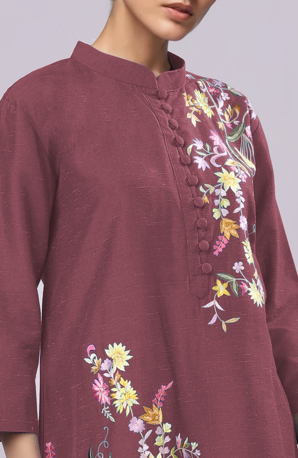 A maroon Parsi Gara embroidered co-ord set with a band collar and potli buttons.