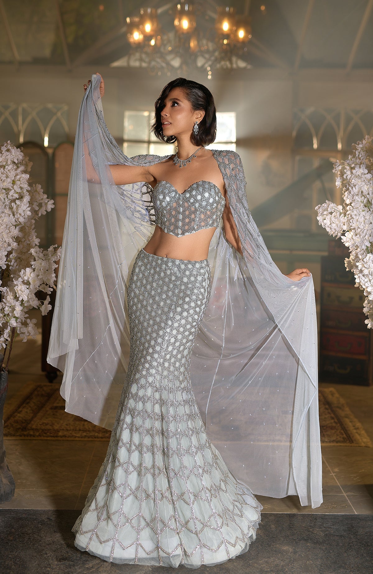 Blue crystal hand-embroidered mermaid lehenga with cape and intricate silver hexagonal beadwork.