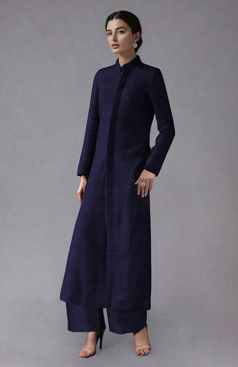 An elegant woman models an Eclipse Blue Raw Silk Jacket Set with wide-leg pants.