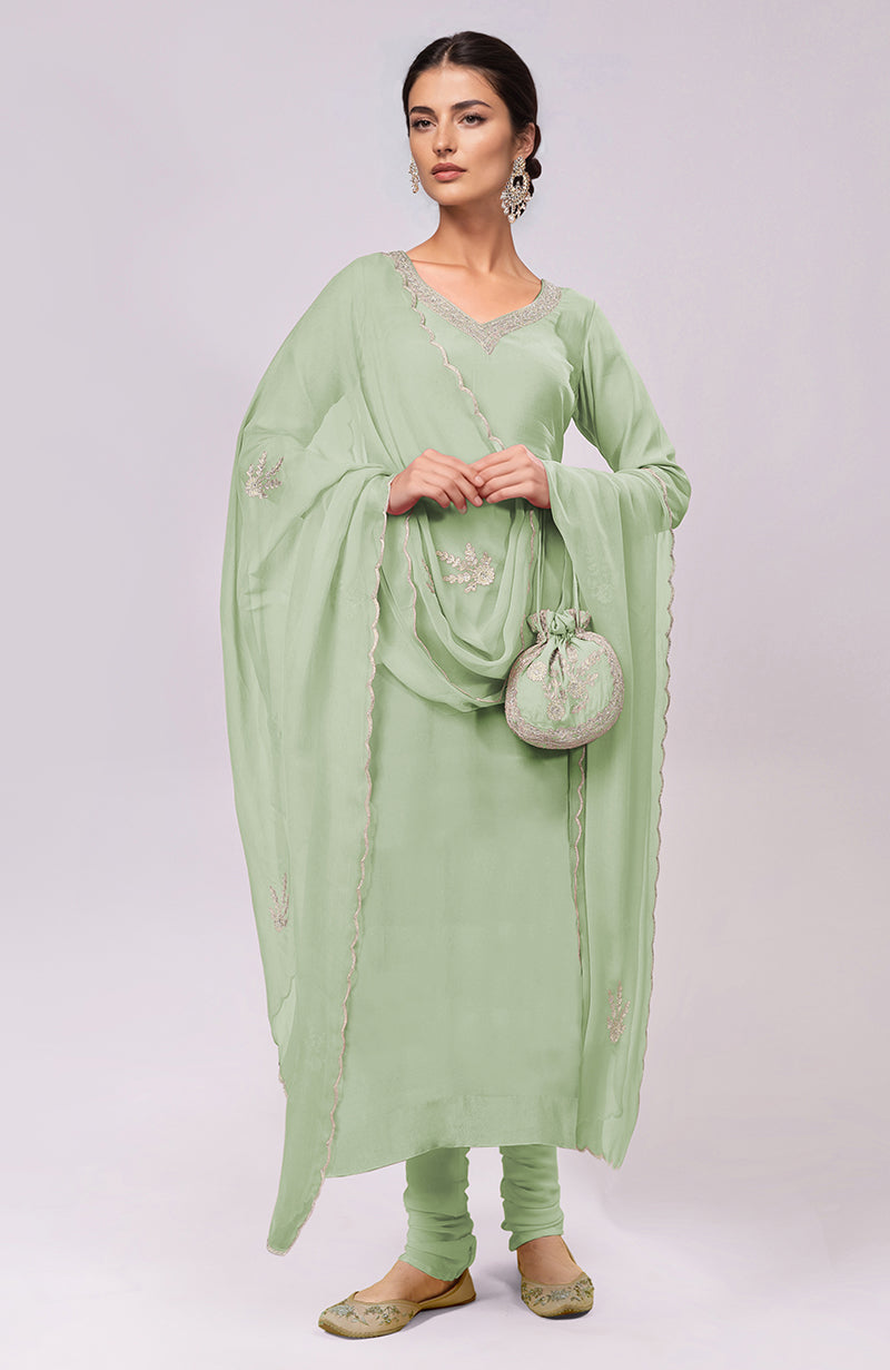 Sage green Kashmiri Tilla Aari embroidered kurta set with a matching potli bag.