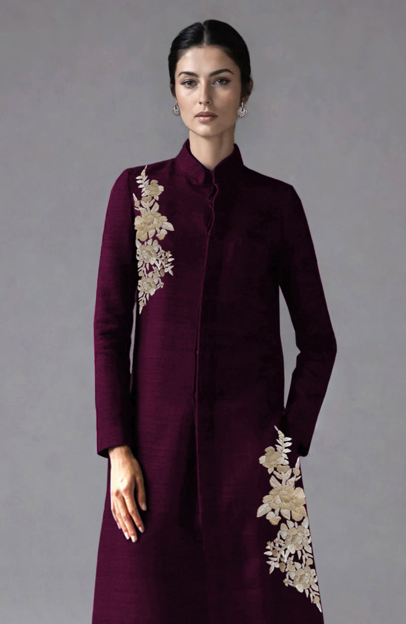 Wine-colored raw silk sherwani jacket with Parsi Gara floral embroidery and wide-leg pants.