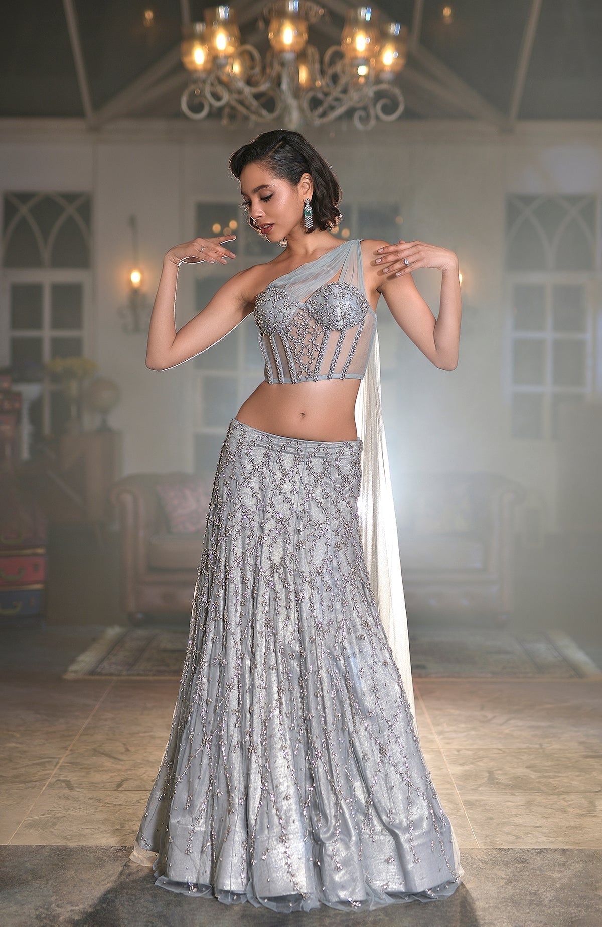 Silver grey hand-embroidered corset lehenga set with silver crystal floral designs and one-shoulder cape