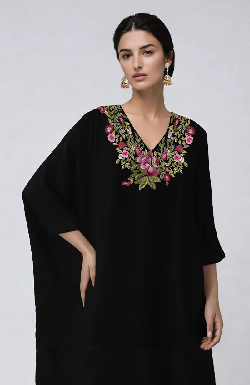 Black kaftan with vibrant floral embroidery along the V neckline and loose flowing sleeves