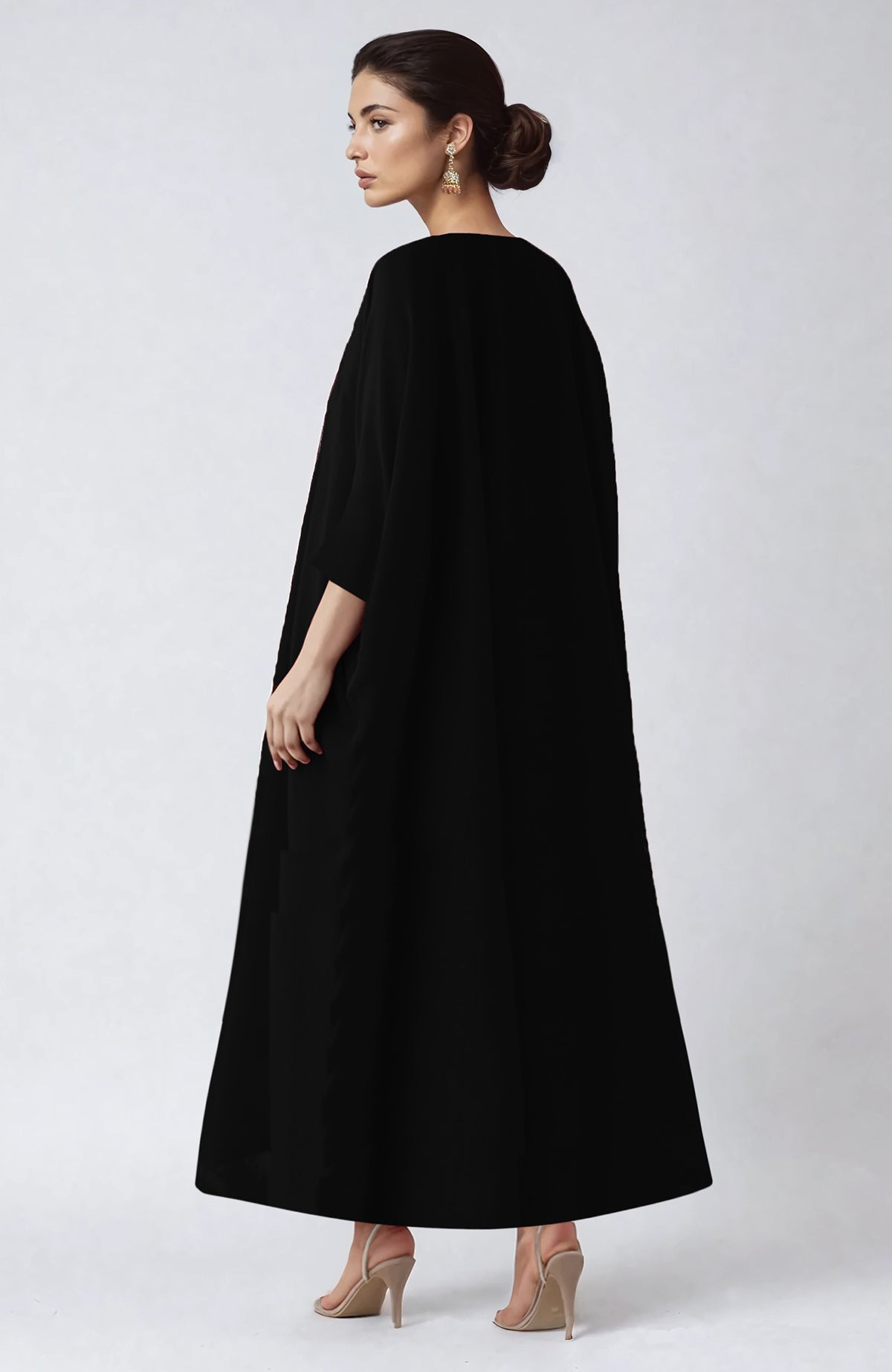 Black kaftan with vibrant floral embroidery along the V neckline and flowing sleeves