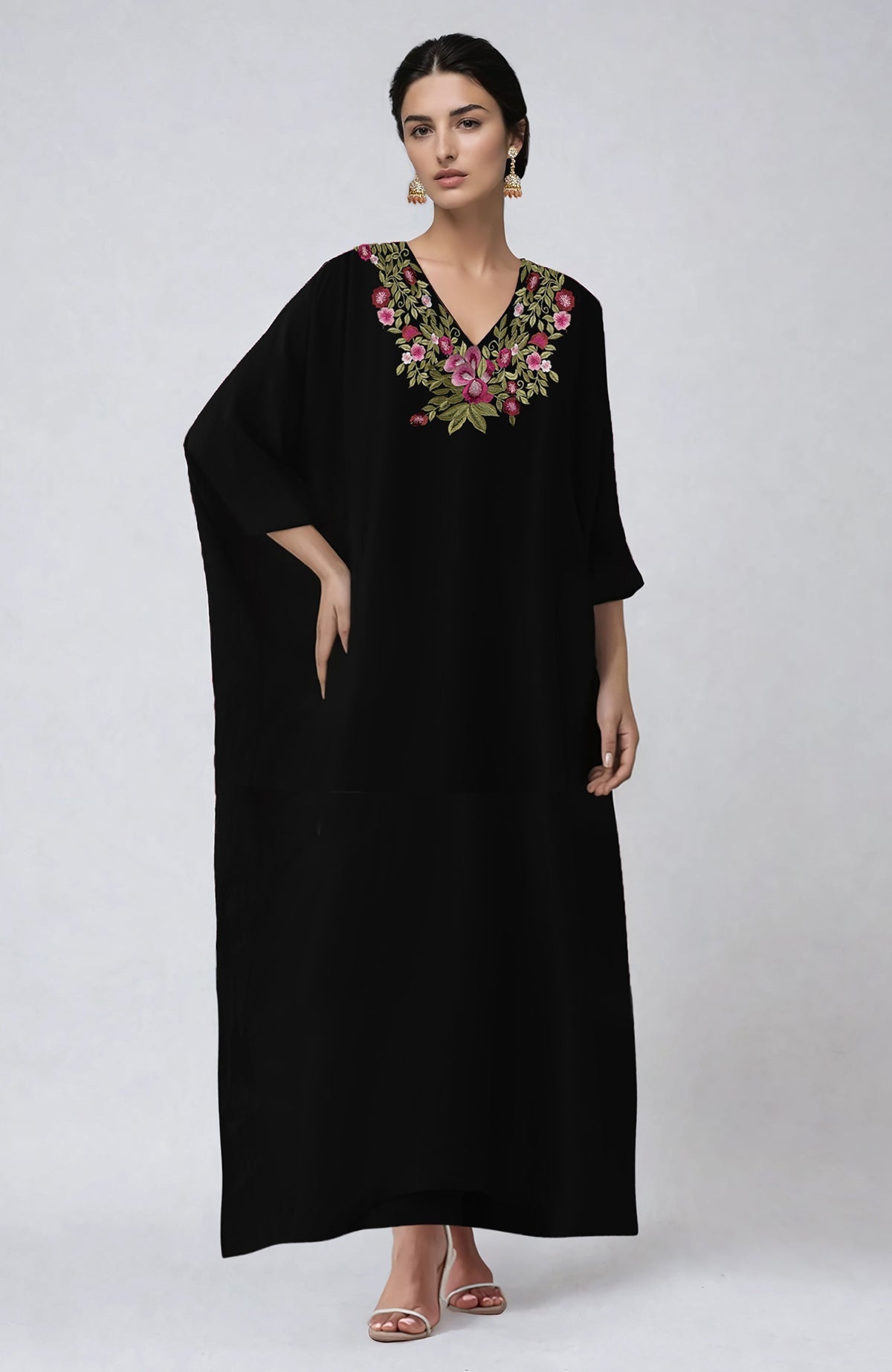 Black kaftan with vibrant floral embroidery along the V neckline and flowing silhouette