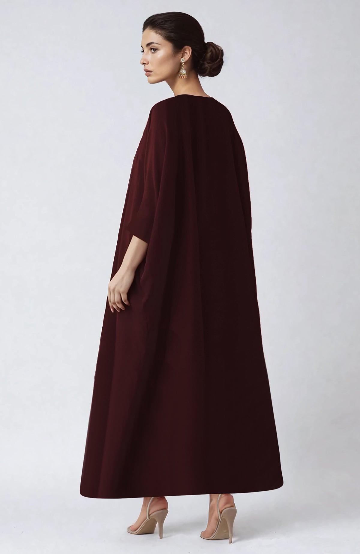 Wine-colored kaftan with intricate Kashmiri Tilla Aari embroidery along the placket.