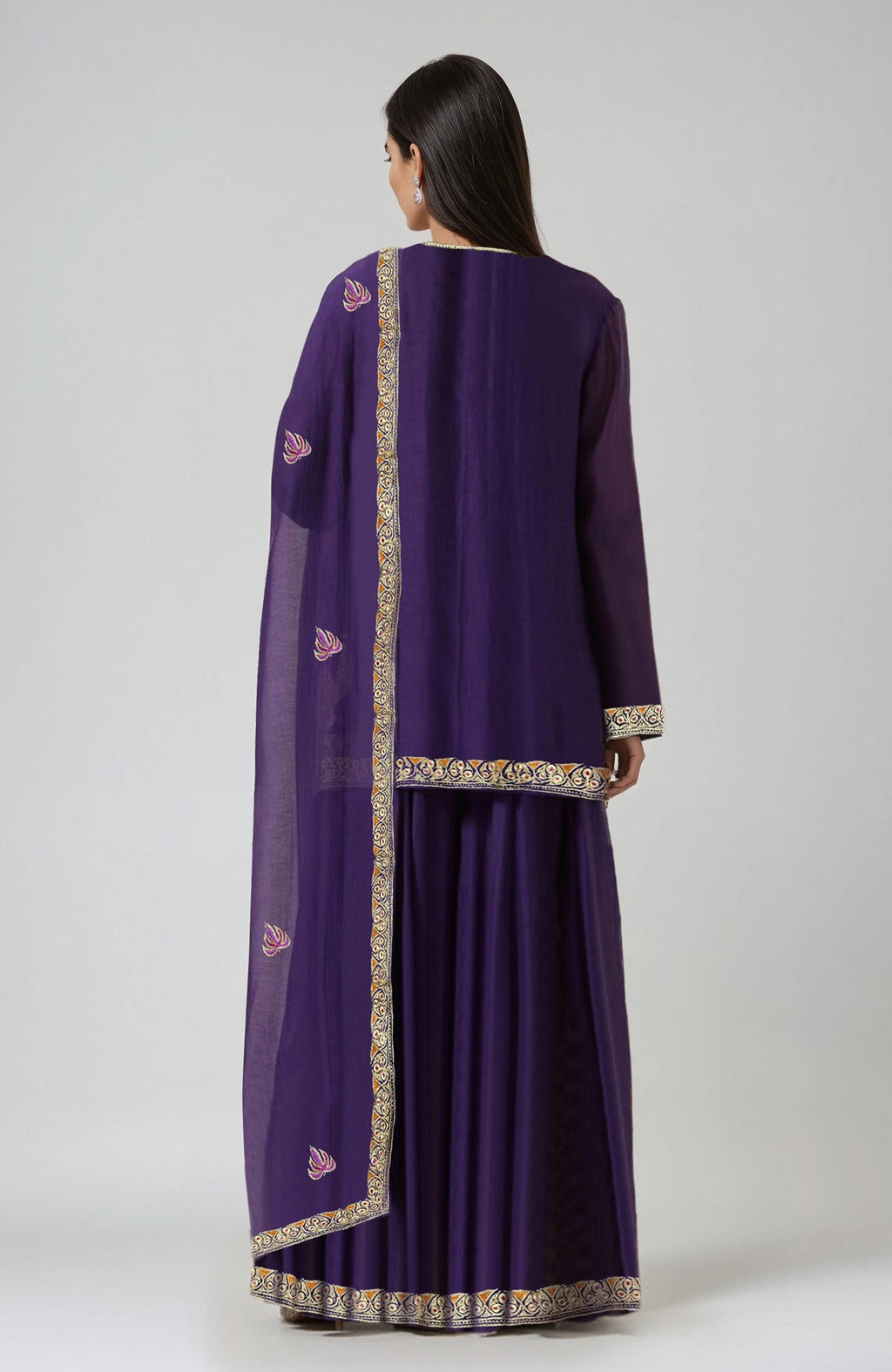 A woman from behind wears an indigo purple embroidered sharara set.