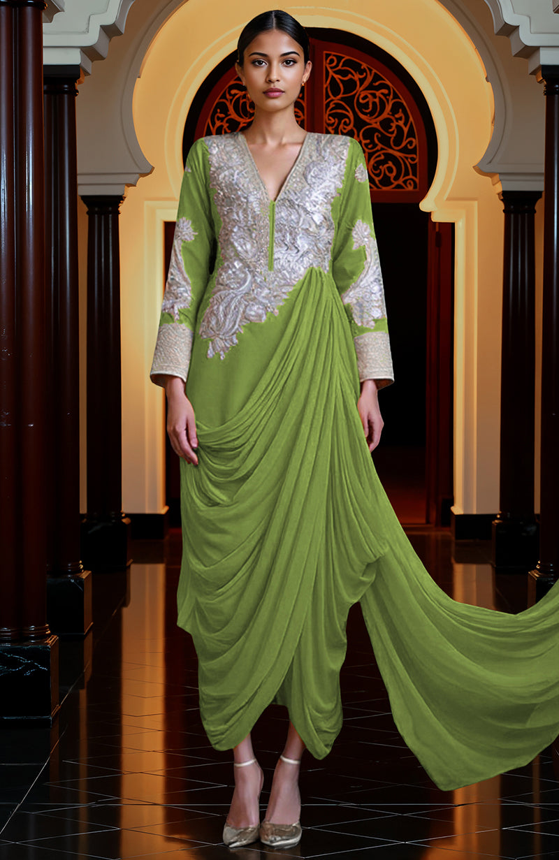 A woman models a mustard yellow draped skirt set with silver embroidery.