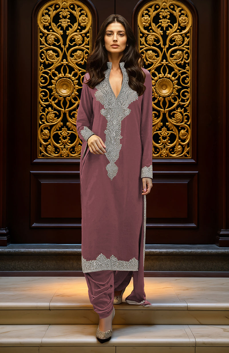 A woman models a mustard yellow embroidered kurta set with silver embellishments.