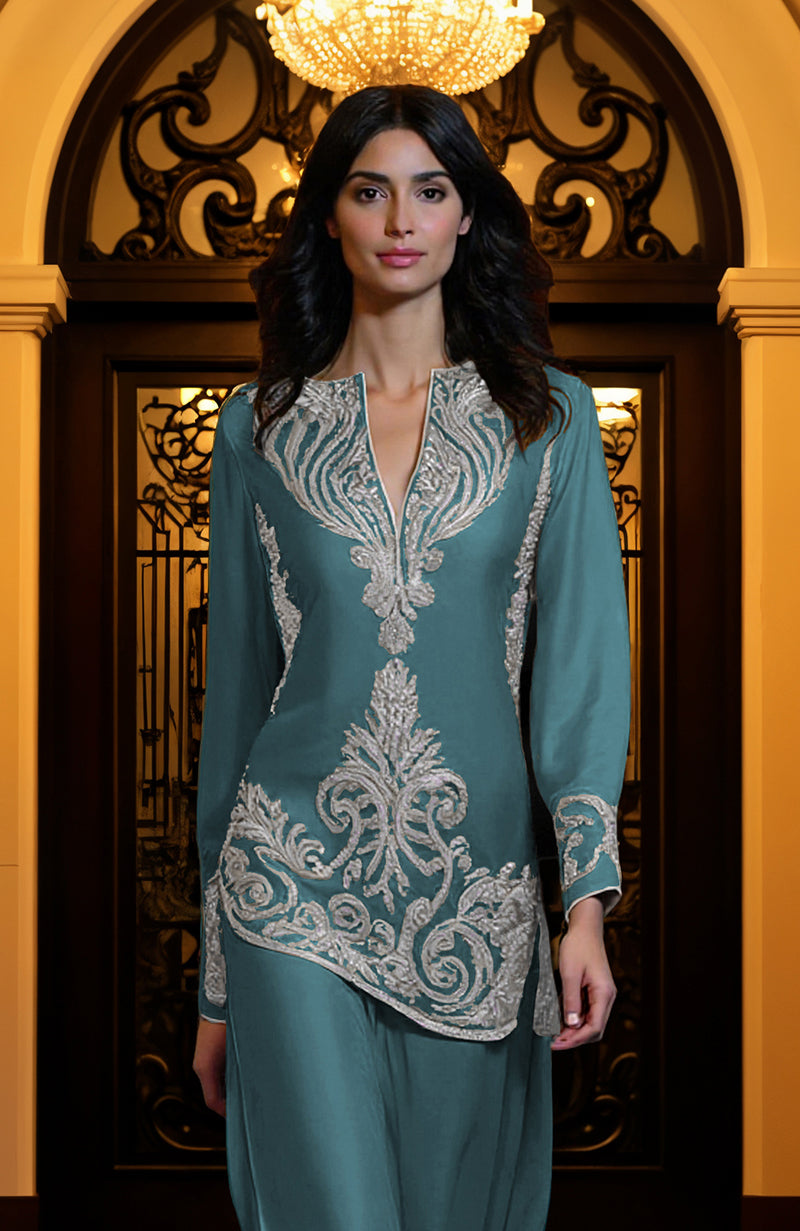 Peacock blue tunic set with silver paisley embroidery, deep V-neck, long sleeves, and wide-leg trousers.