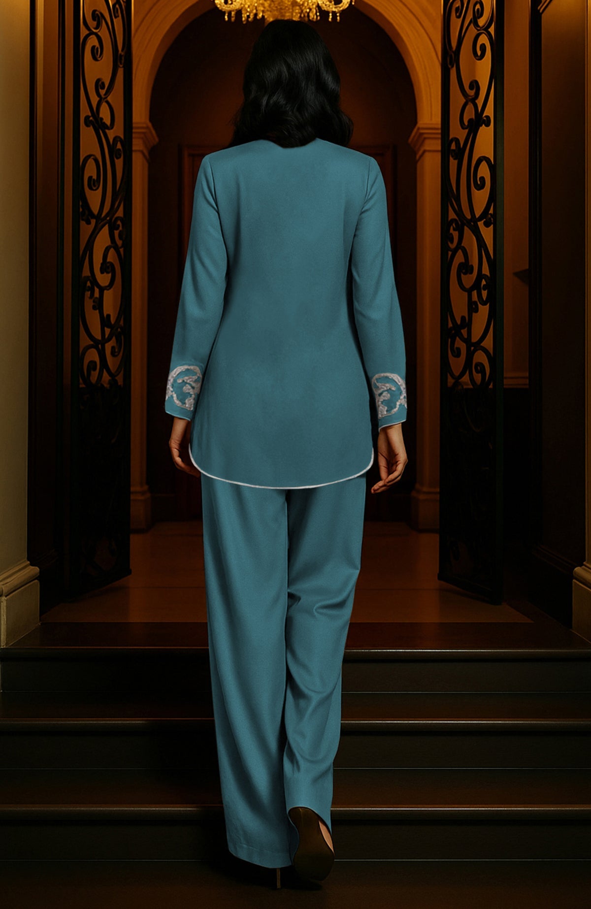 Peacock blue tunic set with silver paisley embroidery, deep V-neck, long sleeves, and wide-leg trousers.