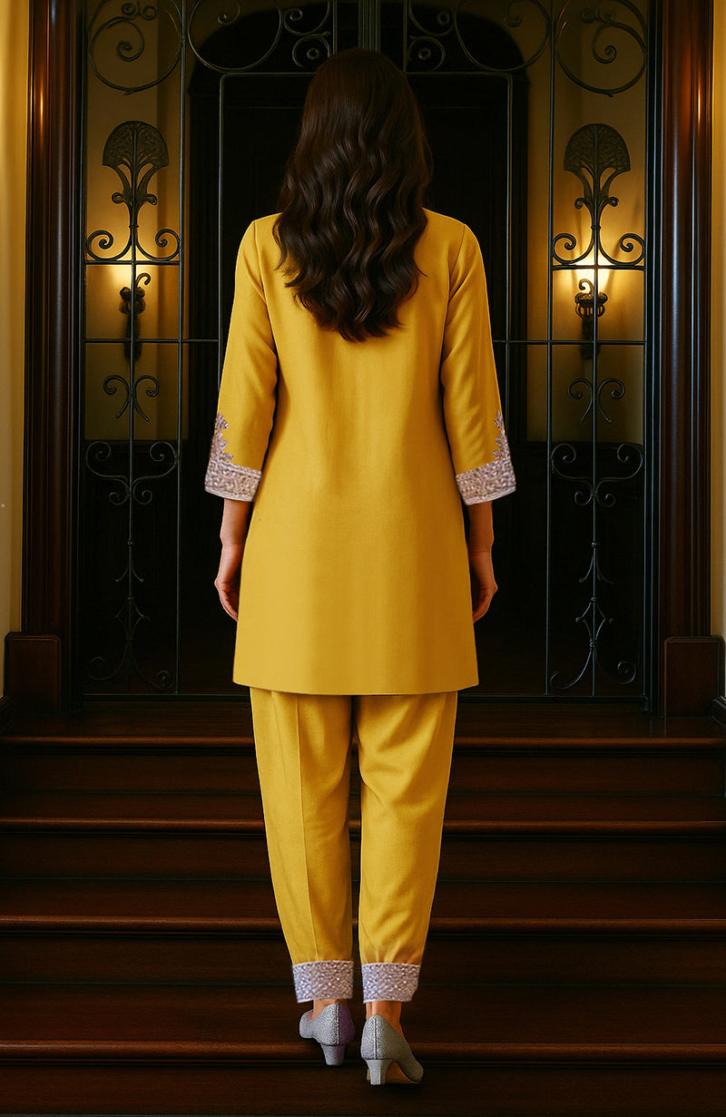 Mustard gold tunic with silver embroidery and matching loose trousers with embroidered cuffs.