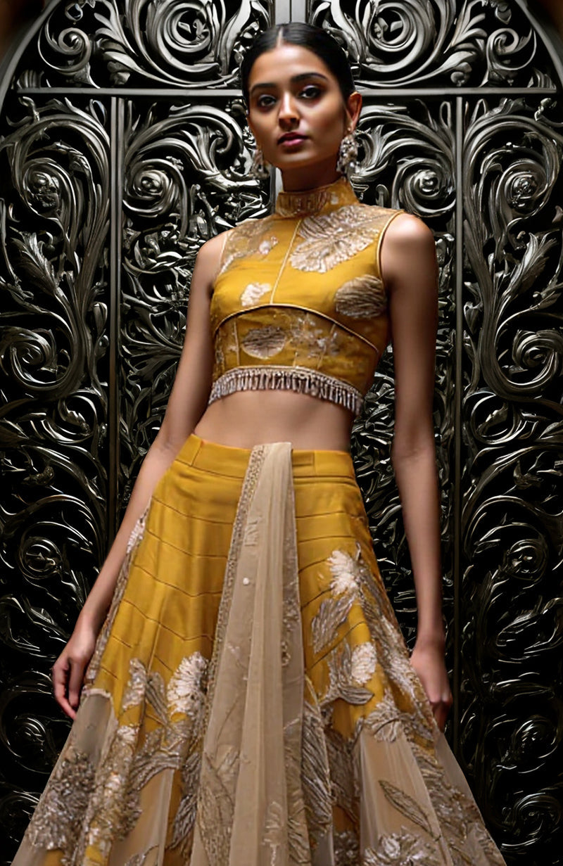 Mustard gold lehenga set with sleeveless embroidered blouse, flared skirt, and sheer dupatta.