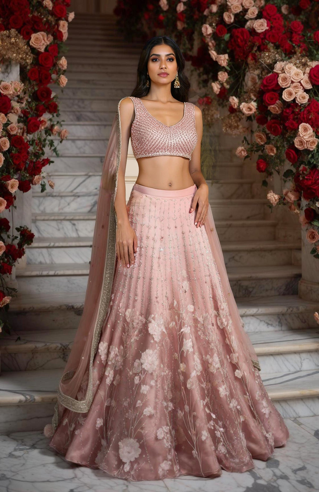 Blush pink lehenga set with sleeveless embellished blouse, floral embroidered skirt, and sheer dupatta.