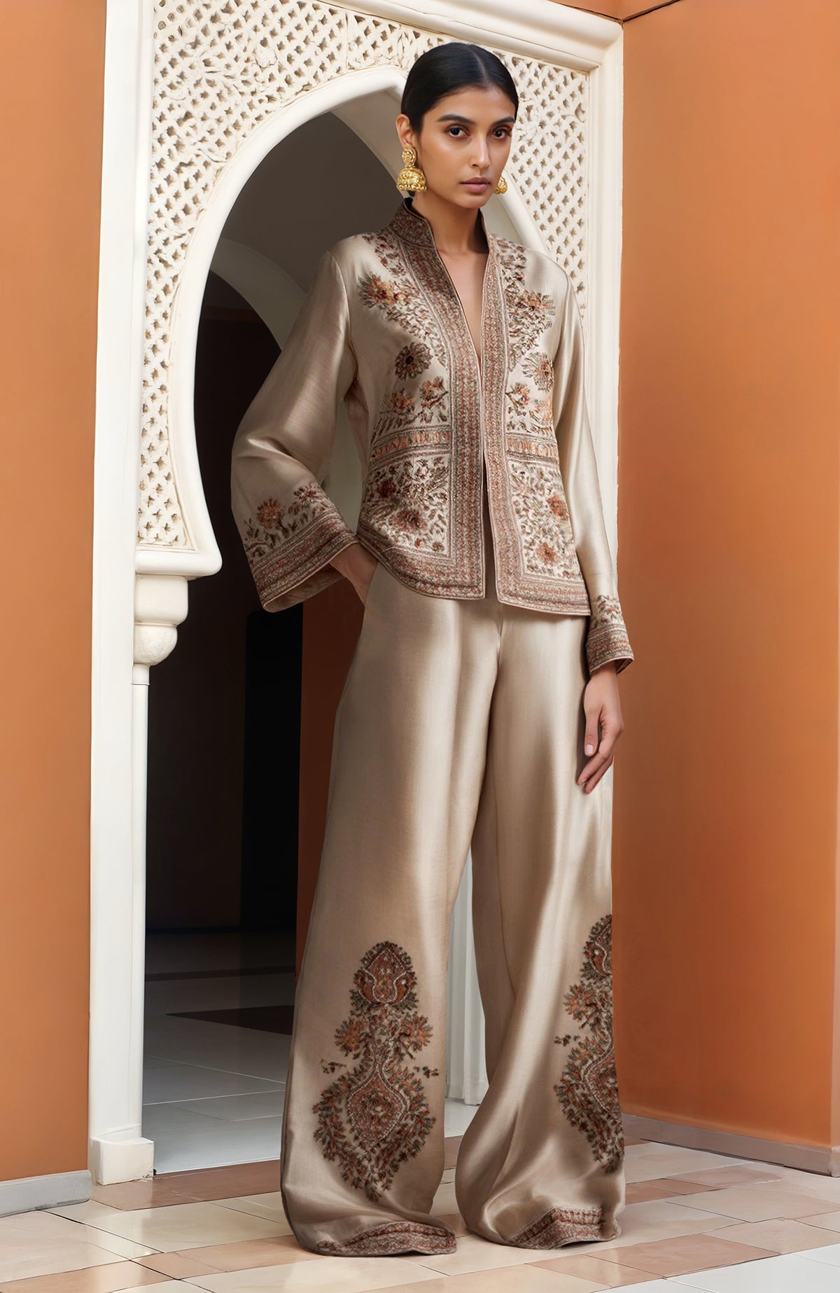 Champagne Kashidakari Jamawar jacket with floral embroidery paired with wide-leg trousers.