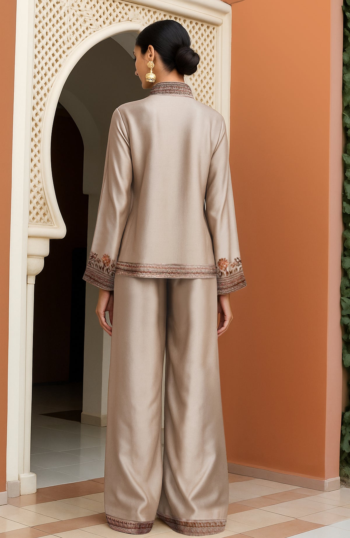 Champagne Kashmiri Jamawar jacket with floral embroidery paired with wide-leg trousers.