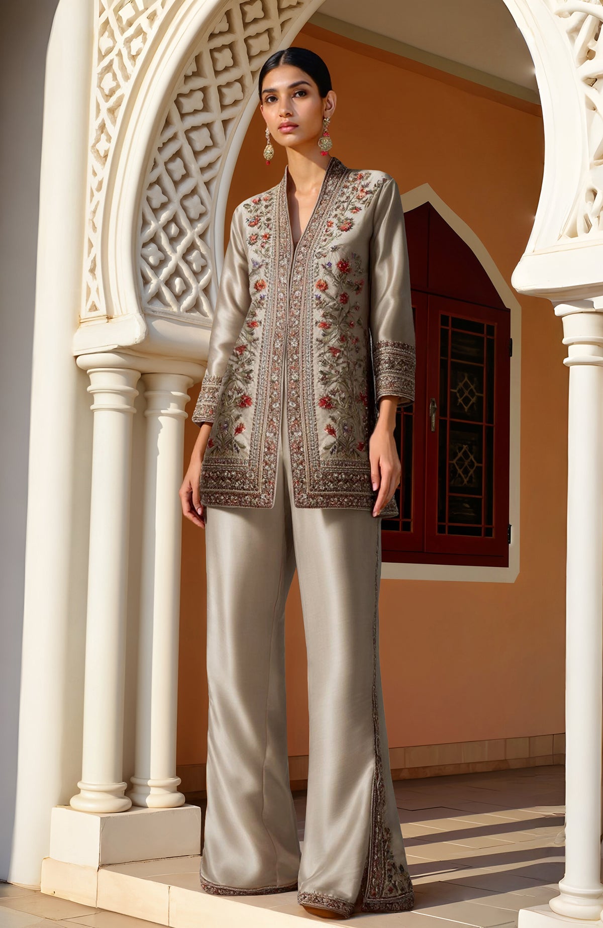 Champagne-colored Kashidakari embroidered jacket with floral motifs paired with wide-leg trousers.