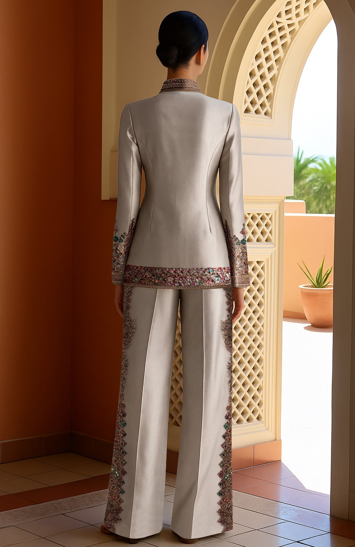 Ivory silk blazer with crystal embroidery and wide-leg trousers with sequin side panels.
