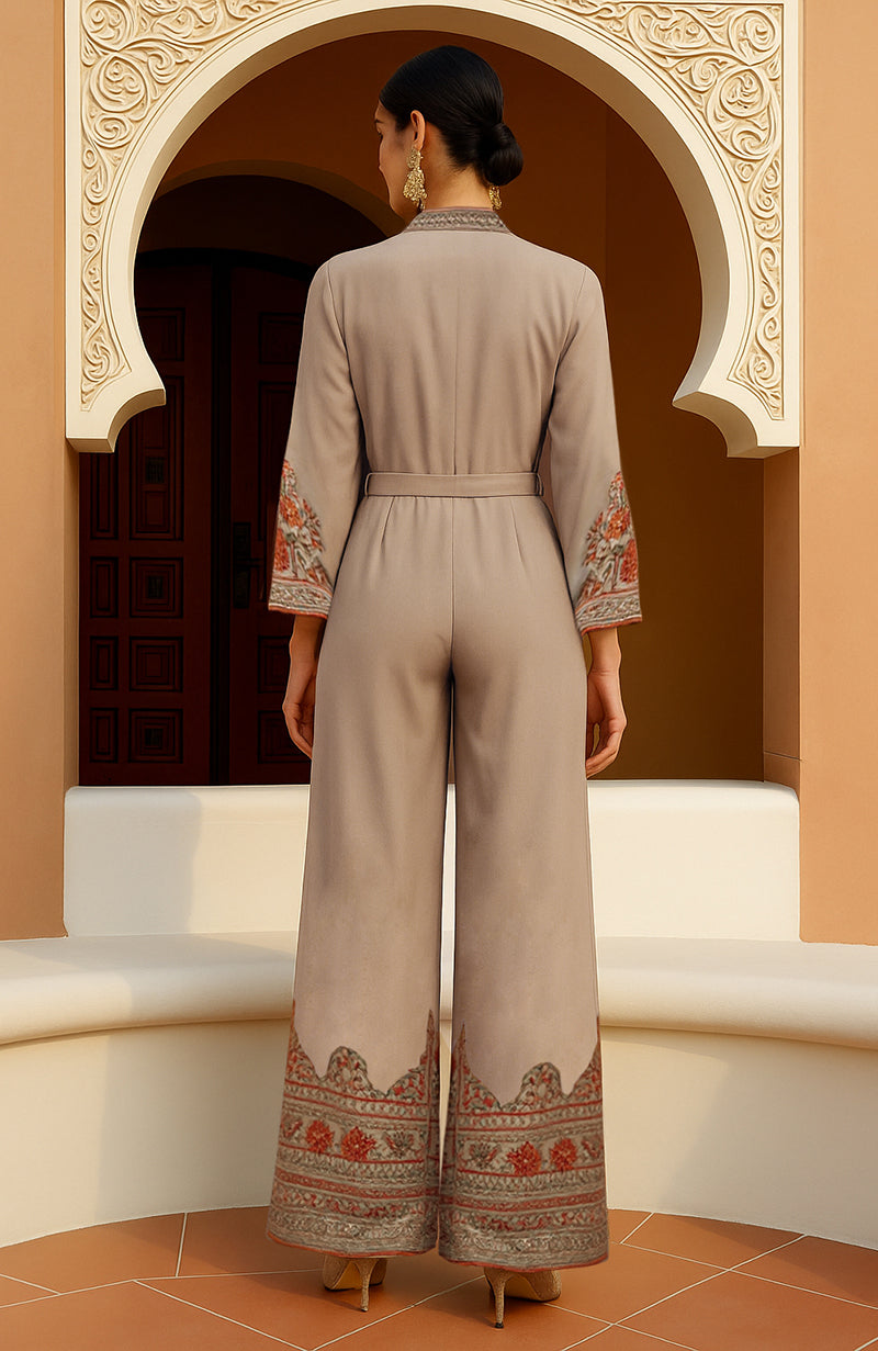 Beige belted jumpsuit with jamawar embroidery, deep V-neck, full sleeves, and wide-leg pants.