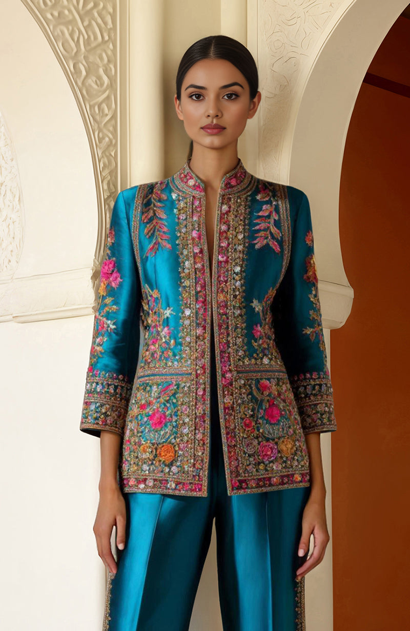 Teal two-piece ensemble with floral zardozi and resham embroidery, long jacket, and flared palazzo pants.
