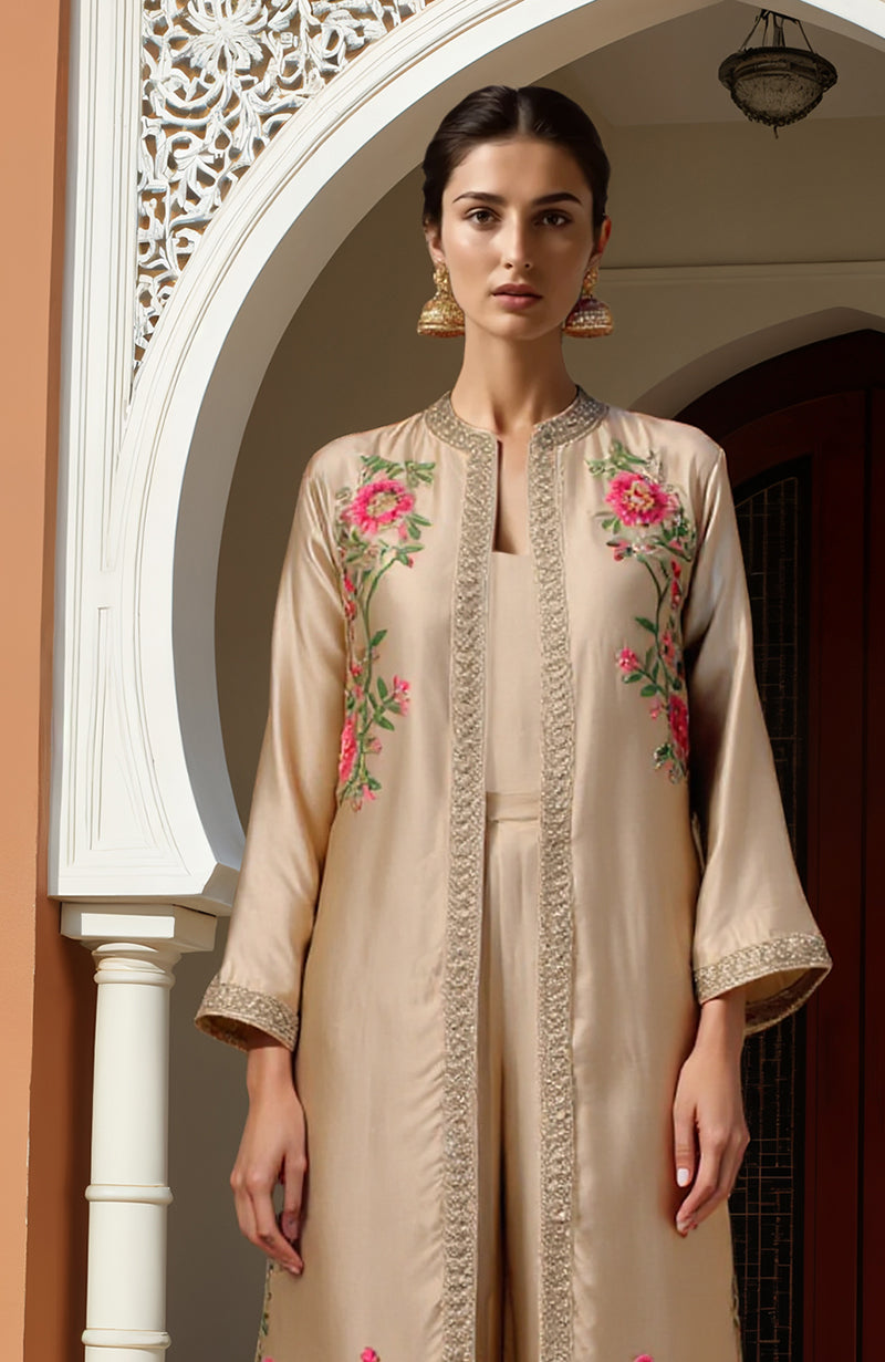 Beige paper mache Kashidakari embroidered long jacket with floral designs, matching trousers, and camisole.