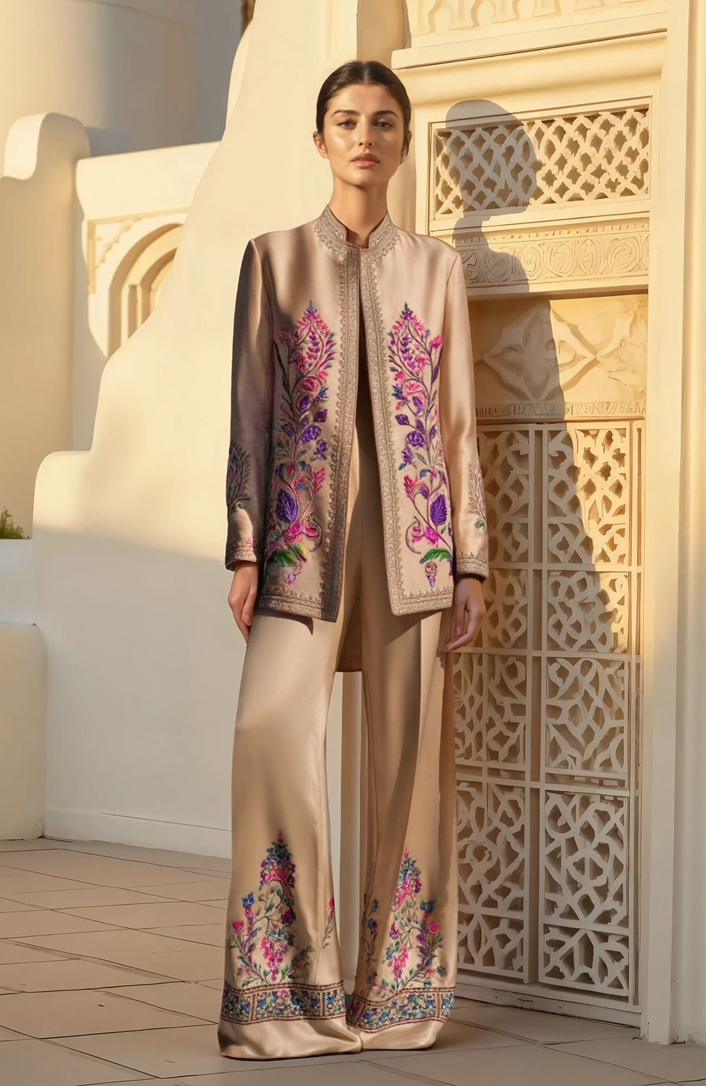 Beige pantsuit with longline jacket and wide-leg trousers featuring multicolored floral embroidery.