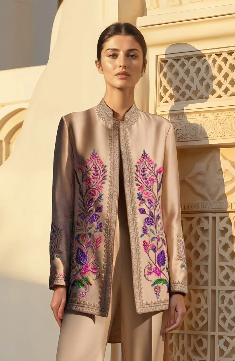 Beige pantsuit with longline embroidered jacket and wide-leg trousers featuring floral Kashmiri motifs.