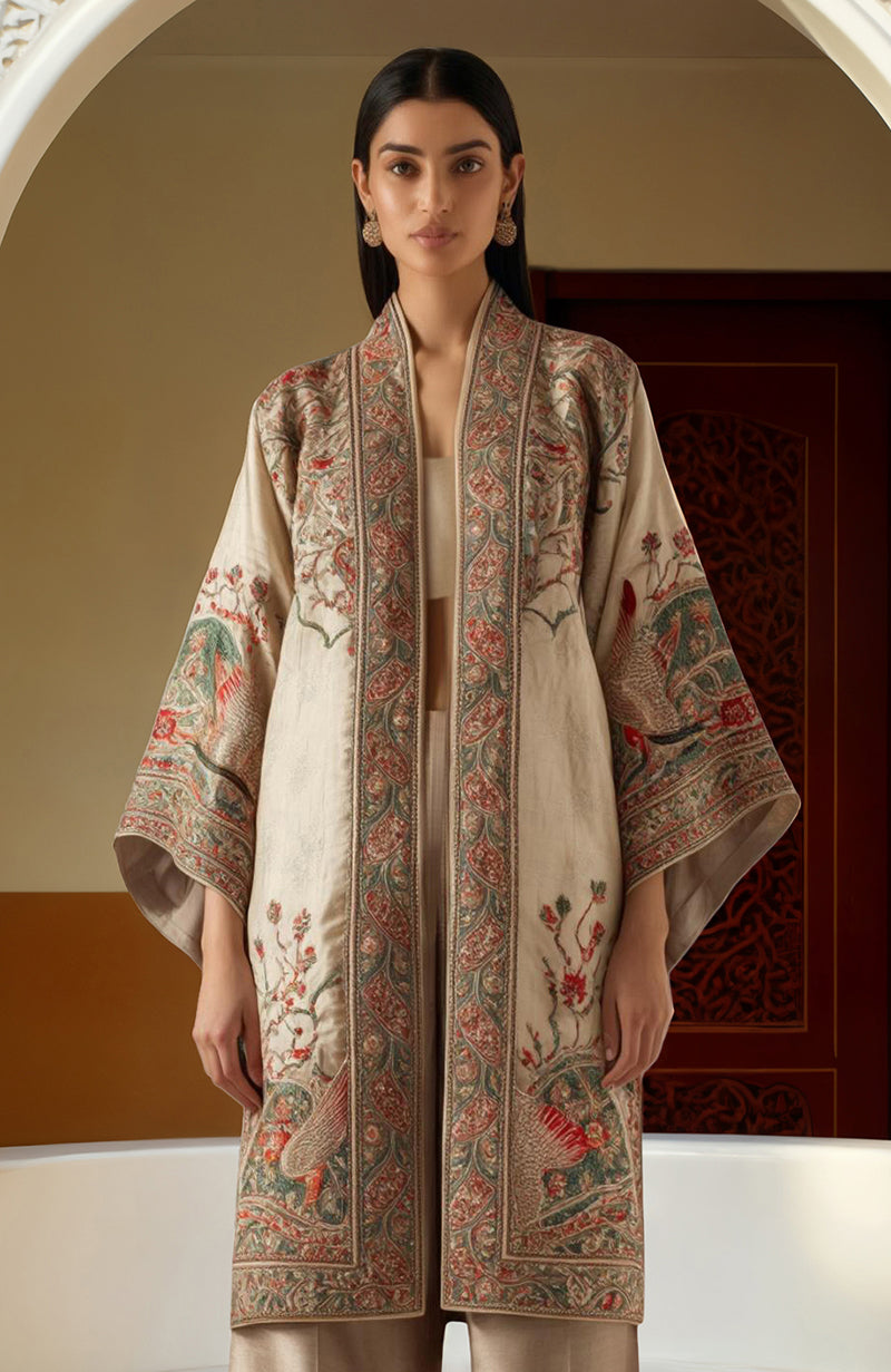 Ivory kimono jacket set with embroidered floral motifs in red, green, and gold, wide sleeves and flowing silhouette.