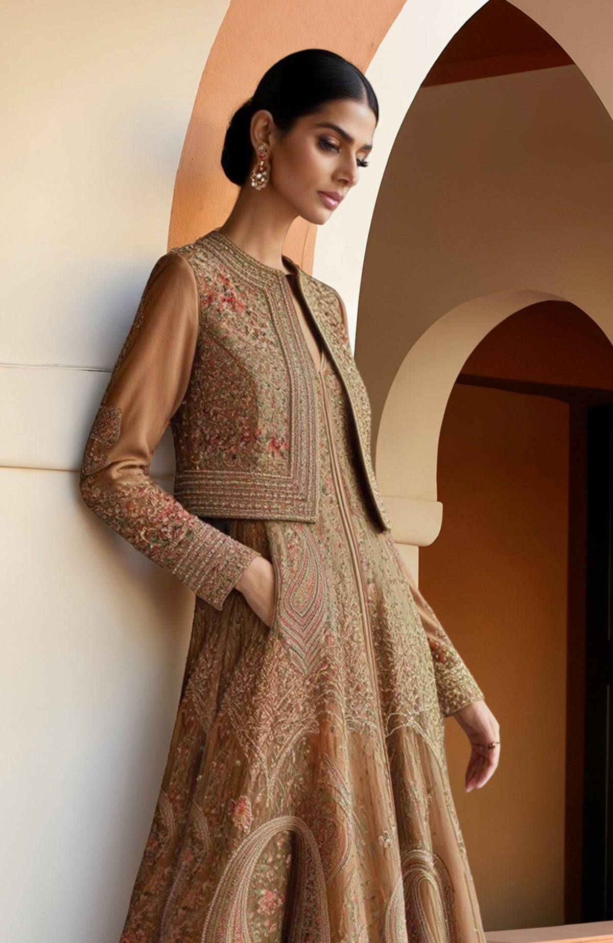 Earthy brown Anarkali gown with intricate paisley embroidery and a matching cropped jacket.