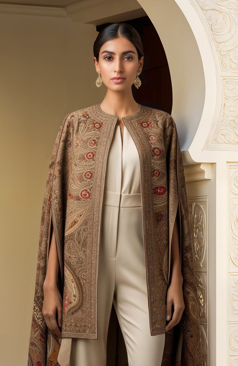 Ivory jumpsuit with pleated bodice paired with brown paisley embroidered open-front cape