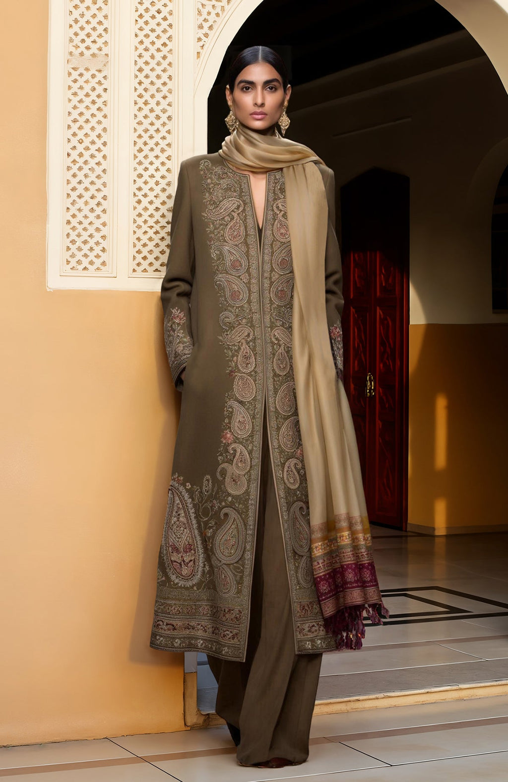 Olive long jacket with intricate paisley embroidery paired with a high-waisted wide-leg jumpsuit