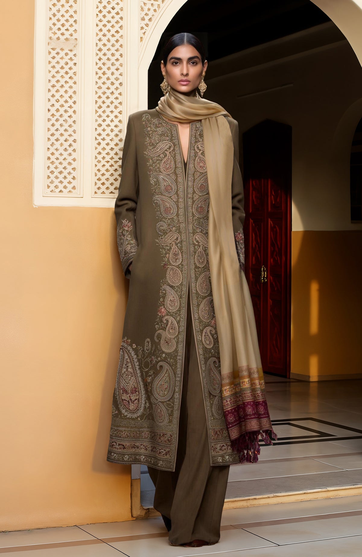 Olive long jacket with intricate paisley embroidery paired with a high-waisted wide-leg jumpsuit