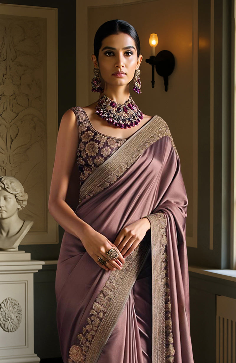 Deep mauve saree with gold floral embroidery and a sleeveless embroidered blouse.