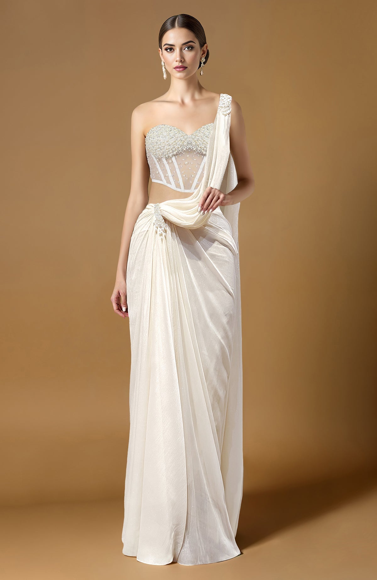 Ivory saree with pearl-embellished corset blouse featuring a sweetheart neckline and one-shoulder drape