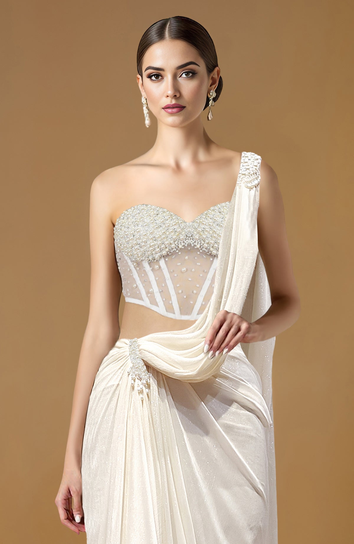 Ivory draped saree with pearl-embellished corset blouse featuring a sweetheart neckline and one-shoulder detail
