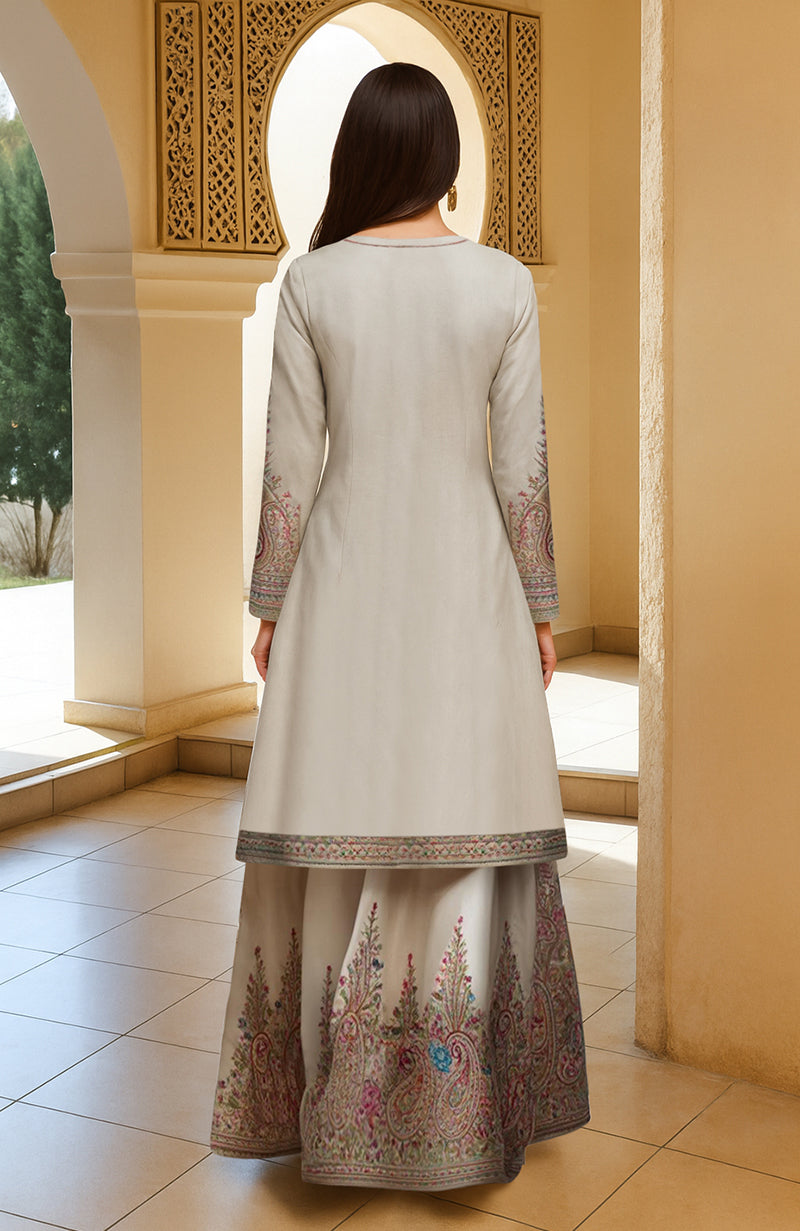 Ivory paisley embroidered long kurta with matching flared skirt and dupatta set.